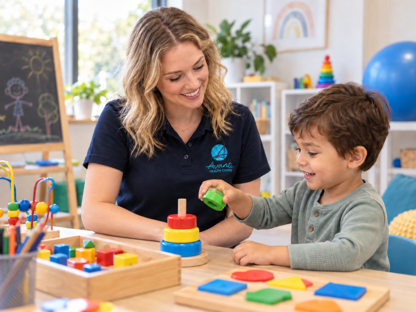 Paediatric occupational therapist playing with a child during therapy